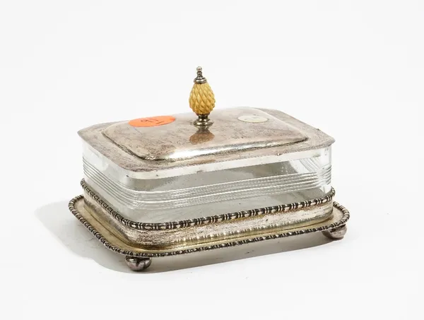 A silver lidded rectangular sardine dish, the detachable cover with a pine cone finial and with a glass liner, having a star cut base, Chester 1920, c