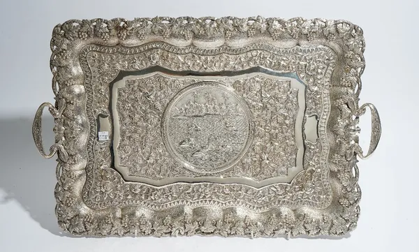 An Asian shaped rectangular twin handled tray, the central reserve decorated with elephants bathing, with palm trees and buildings beyond, in a surrou