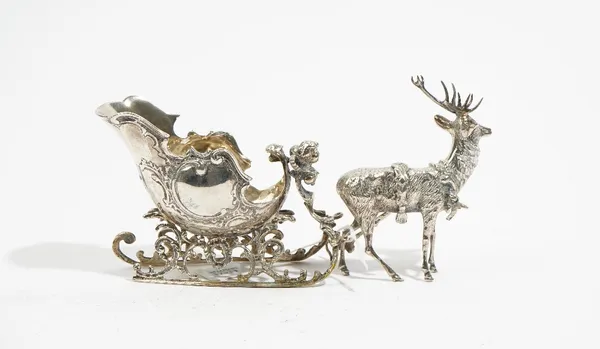 A foreign cast model of a sleigh with a reindeer, length 24cm.