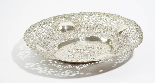 A German oval centrepiece dish, embossed and pierced with fruit, flowers, foliage and scrolls and with four vacant cartouches at intervals, detailed 8