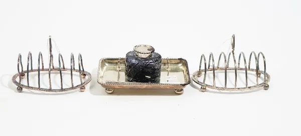 Silver, comprising; a rectangular pen and ink stand, decorated with a gadrooned rim, raised on four bun feet, Chester 1903, with a silver mounted face