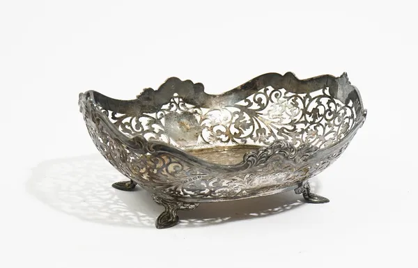 A silver bonbon basket, with scroll pierced decoration below a cast scrolling rim, raised on four feet, Sheffield 1926, 20.5cm long, 255 gms.