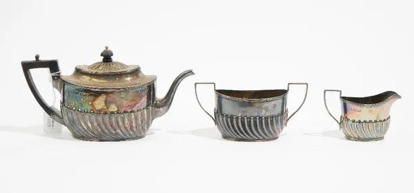 A Victorian bachelor's silver three piece tea set, Sheffield 1887, of oval form, with partly fluted embossed decoration, gross weight 427 gms.