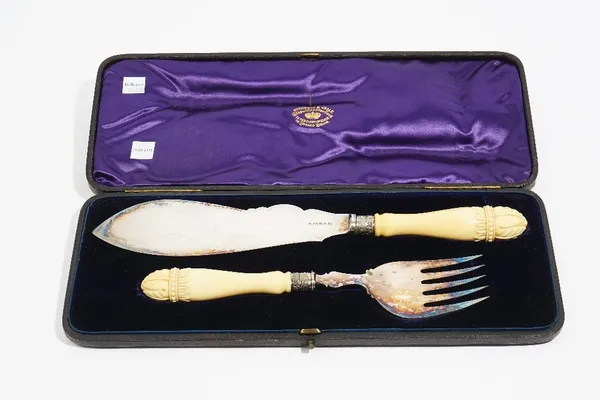 A pair of Victorian silver fish servers, undecorated, having ivory handles with carved terminal, Sheffield 1877, with the original fitted case.