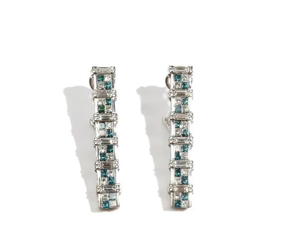 A pair of white gold, treated blue diamond and diamond set earrings, each designed as a row of six four stone clusters, with baguette diamonds at inte