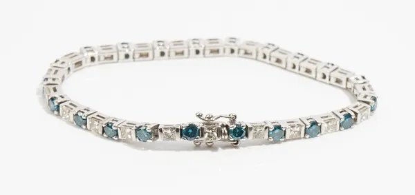 A white gold, treated blue and diamond line bracelet, mounted with a row of alternating circular cut treated blue diamonds and princess cut diamonds,