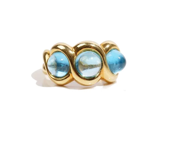 A blue topaz-set dress ring, set with three blue topaz cabochons, in an 18ct gold mount, gross weight 10.5gms, with an associated Cartier case.