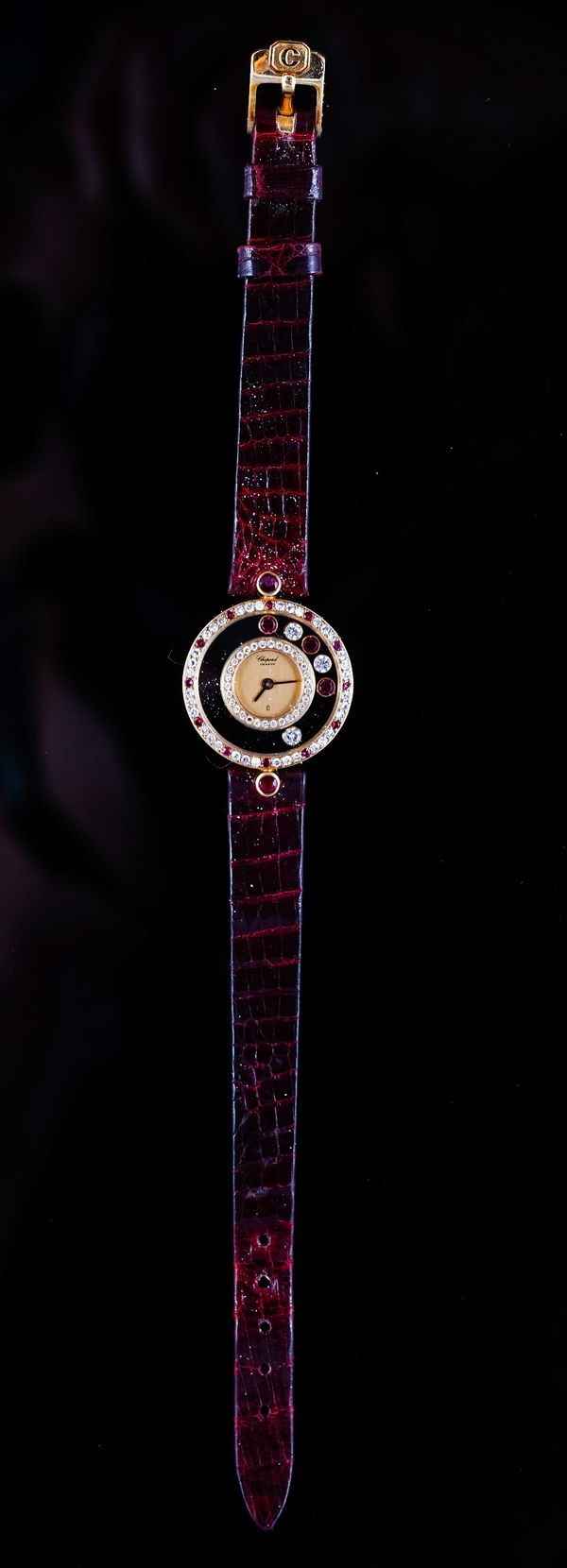 A Chopard, Geneve gold, diamond and ruby set Happy Diamonds lady's dress wristwatch, with a signed gilt dial, having a surround of circular cut diamon