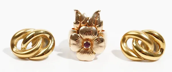 A gold ring designed as a flowerhead mounted with a central ruby above two leaves, apparently unmarked, ring size J and a half, gross weight 13.8 gms