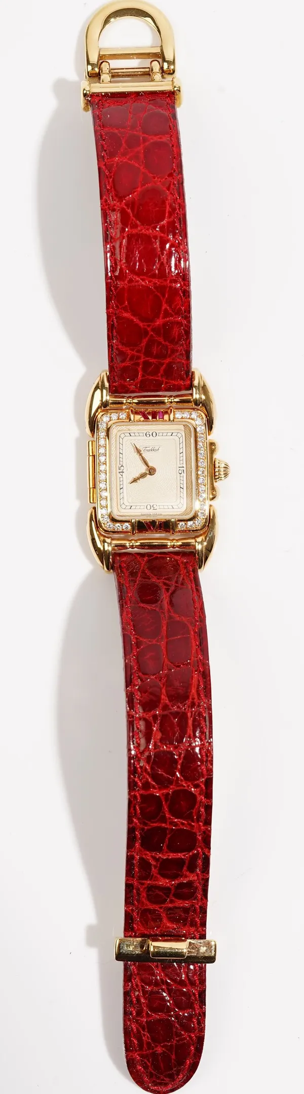 A Tabbah gold and diamond set rectangular cased lady's dress wristwatch, the signed rectangular silvered dial with black Arabic numerals at 15, 30, 45