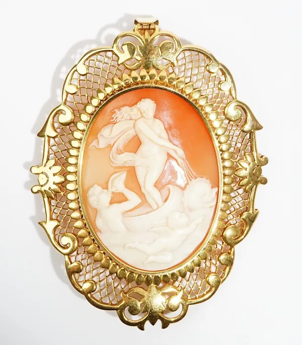 A gold mounted oval shell cameo pendant brooch, carved as a Classical scene with Venus, a dolphin and Cupid, within a scroll pierced border, length in