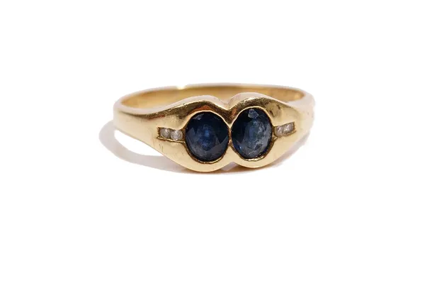 A gold, sapphire and diamond ring, mounted with two oval cut sapphires, between diamond set two stone shoulders, detailed 585, ring size Q and a half,