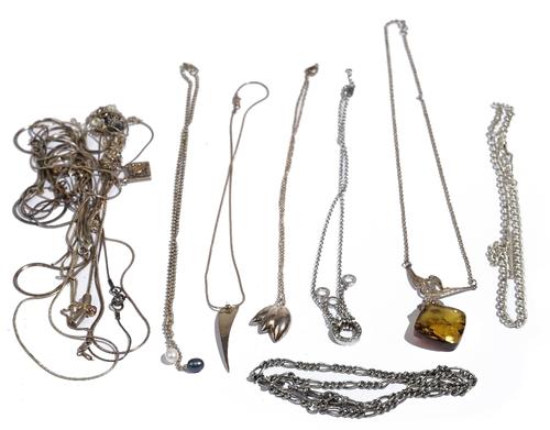 A silver curb link watch chain, fitted with two swivels and a T bar, detailed SILVER, a reconstituted amber pendant necklace and fourteen mostly silve