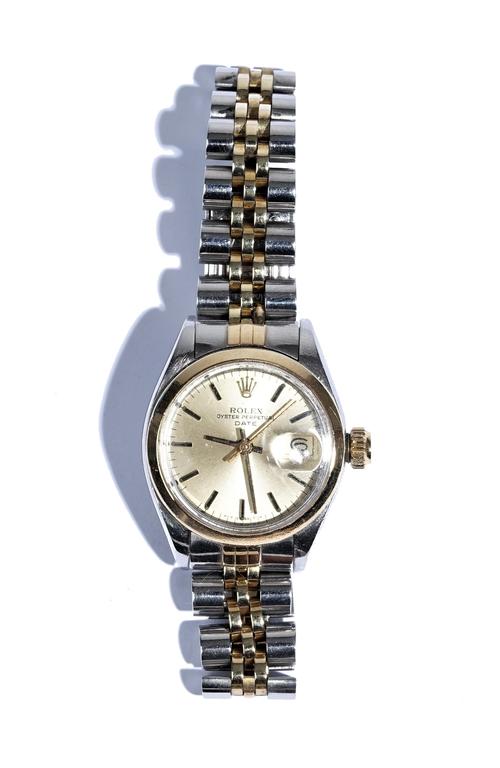 A Rolex Oyster Perpetual Date steel and gold lady's bracelet wristwatch, the signed dial with black baton numerals, centre seconds and with a date of