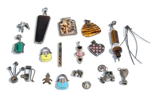 A silver and malachite pendant, detailed 925, a silver, red and colourless gem set heart shaped pendant, detailed 925 and eighteen further silver and