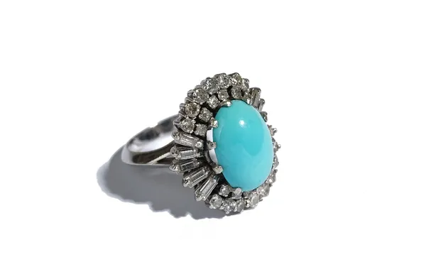 A turquoise and diamond oval cluster ring, claw set with the oval turquoise in a surround of circular cut and baguette diamonds, apparently unmarked,