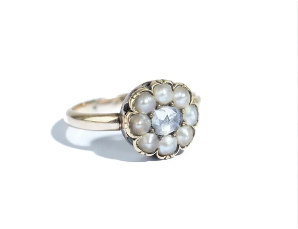 A gold, rose diamond and half pearl set cluster ring, mounted with the central rose diamond in a surround of eight half pearls, ring size M and a half