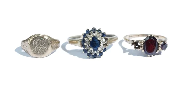 A 9ct gold ring, mounted with two garnets (the third garnet lacking), a gold, sapphire and colourless gem set oval cluster ring (two sapphires lacking