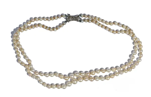 A two row necklace of cultured pearls, graduating in size to the front, on a rose diamond set clasp, detailed 9 C.