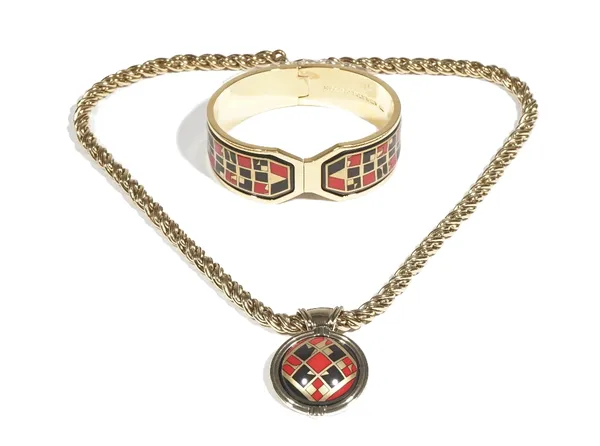 A Michaela Frey Wien gilt metal and enamelled hinged bangle, with decorated panels in a red and black geometric pattern, with a case and a pendant nec