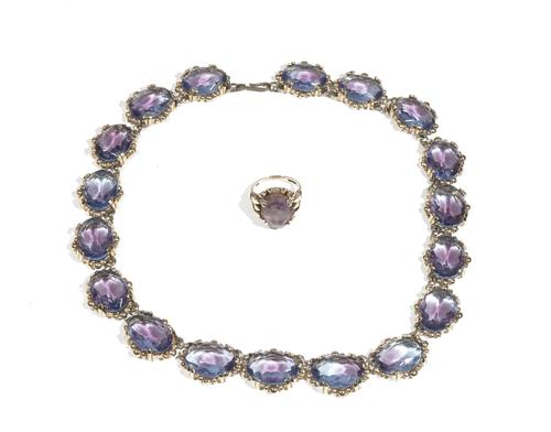 A 9ct gold and amethyst dress ring, the oval-cut amethyst double four claw-set to a scroll work gallery, ring size M, 5.9g; and a matched amethyst col