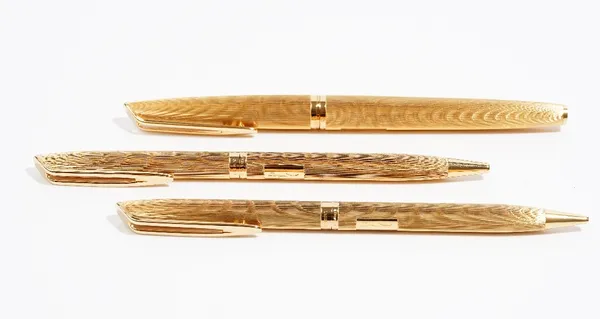 A set of three gold plated pens and pencil set by Waterman, circa 1980, comprising a fountain pen, biro and propelling pencil, in a burgundy suedette