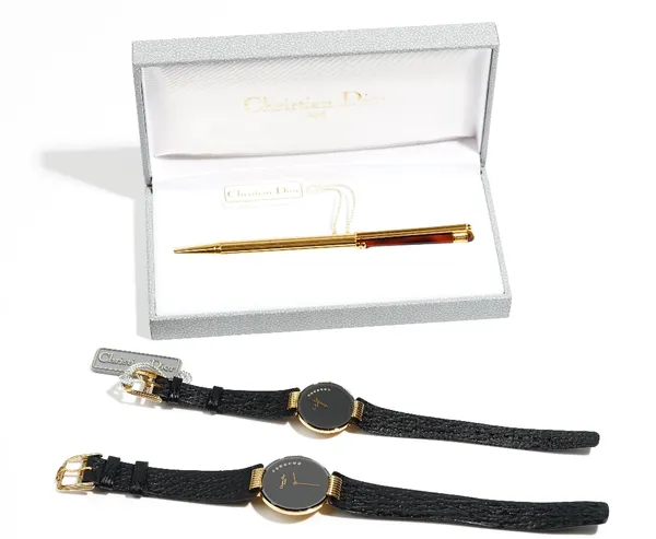 A Christian Dior, Paris gilt metal gentleman's dress wristwatch and a matching lady's dress wristwatch, each with a signed black dial, with the two or