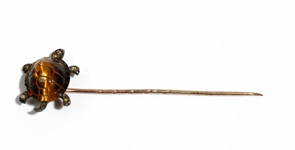 A late Victorian gold and silver set tiger's eye and diamond stick pin, designed as a tortoise, the shell formed from carved tiger's eye, the head and