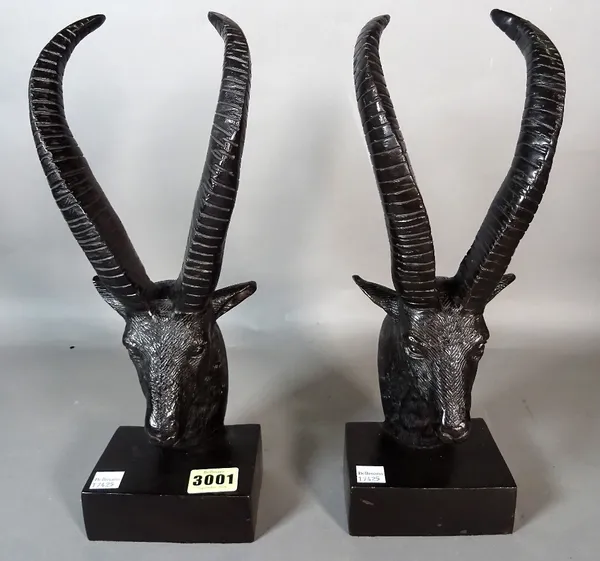 A modern pair of composite bronze bookends formed as an ibex, 32cm high, and a modern wall mounted chrome bust of an antelope, 51cm wide x 40cm high,