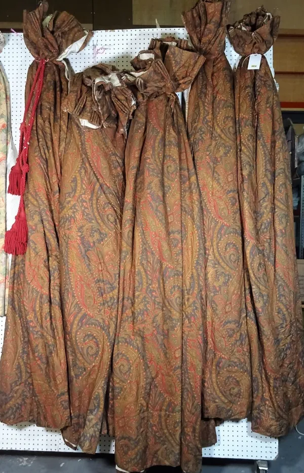 A group of eight lined and interlined curtains, with green and red paisley decoration, to include a set of three, 110cm wide x 230cm long, a pair, 100