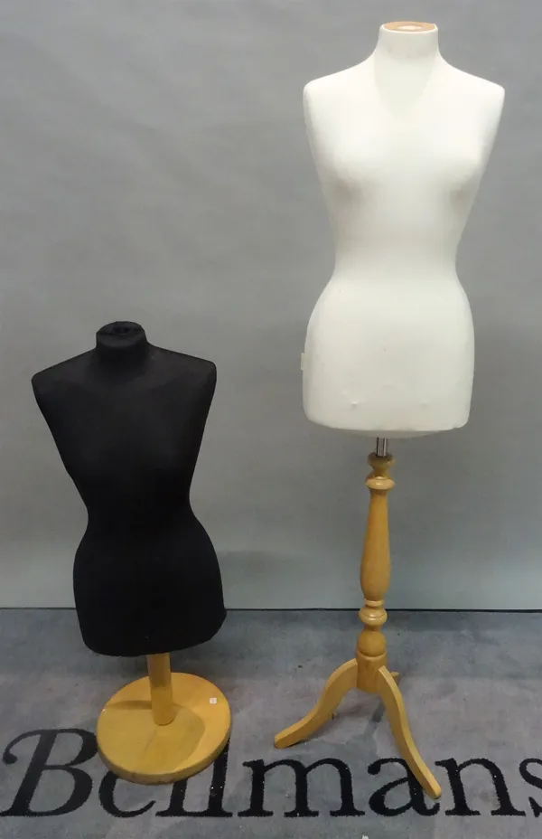 A modern female mannequin torso, on stained beech tripod base and another similar.