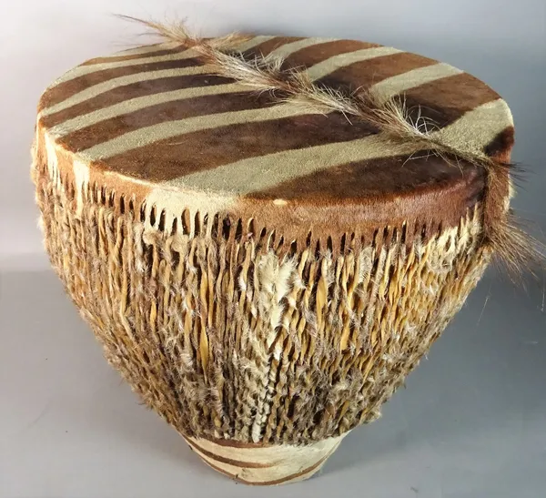 An early 20th century zebra upholstered African circular drum, 39cm diameter x 40cm high.