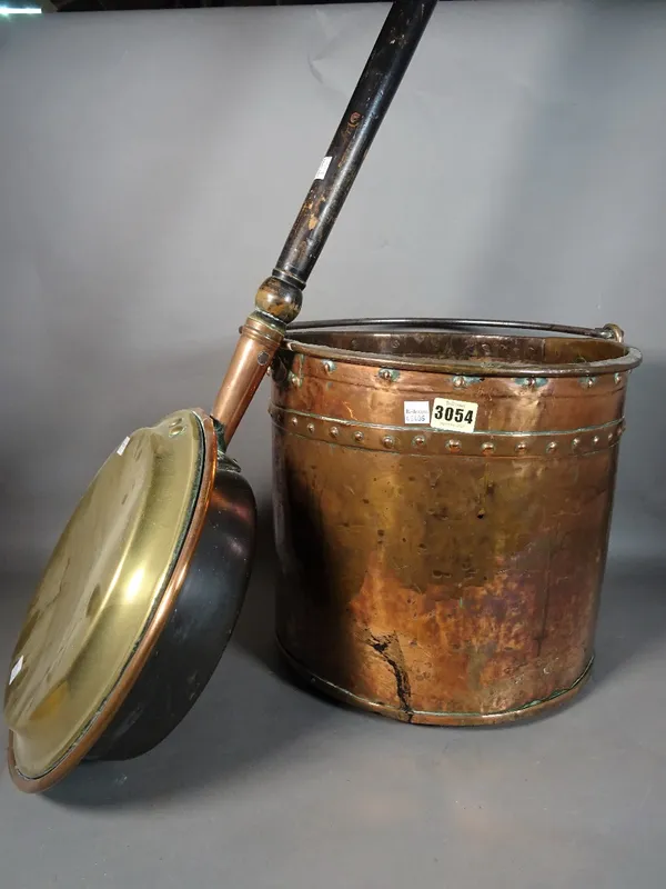 A late Victorian copper bucket, 34cm diameter x 32cm high, and a copper warming pan, (2).