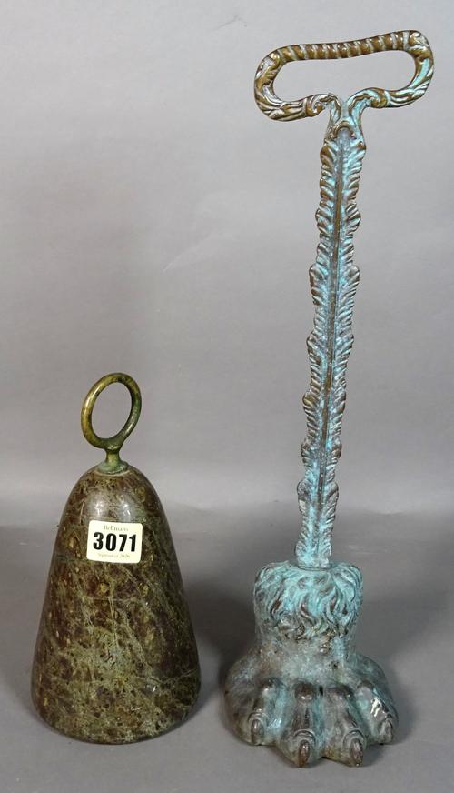 A Victorian bronze door stop, formed as a lion's paw, 37cm high, and a Cornish serpentine doorstop, 17cm high, (2).
