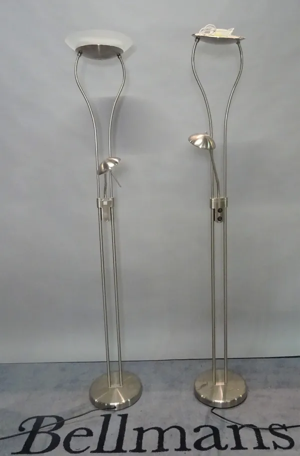 A pair of modern chrome uplighters of tubular form with a mid-tier adjustable reading light and frosted glass dished shades, 178cm high, (2).