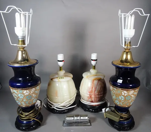 A pair of modern onyx table lamps, 32cm high, a pair of Doulton style lamps, 50cm high, and a small chrome desk calendar, 13cm wide.