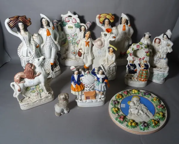 A group of nine 19th century and later Staffordshire Flatback Figures, the tallest 35cm high, and a Staffordshire circular wall plaque, 22cm diameter