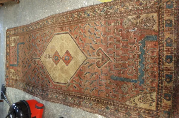 A Semah Hamadan runner, madder field with beige diamond and figure, 267cm x 110cm.