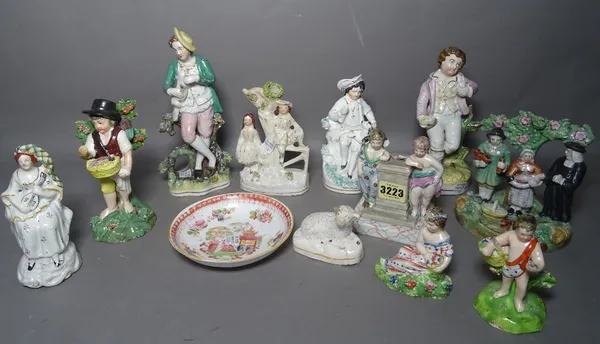 A group of eleven various Staffordshire pottery figures and groups including a Tithe Pig group and a Staffordshire porcelain printed and coloured sauc