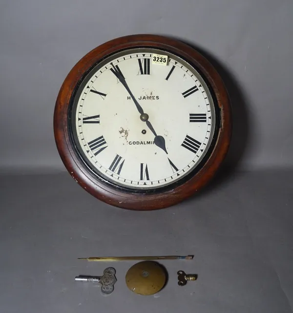 A 19th century mahogany circular wall clock, 40cm wide, with one pendulum and two keys.