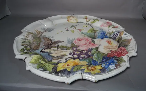 A large modern tile glaze ceramic wall plate painted with bird of prey and flowers, 57cm wide.