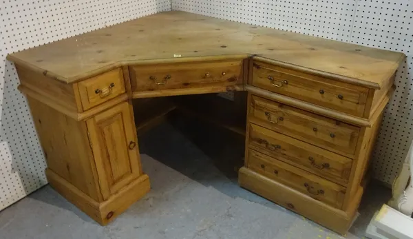 A modern pine corner desk with six drawers about the knee, 147cm wide x 78cm high.