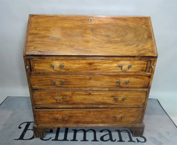 A George III mahogany bureau with four long graduated drawers on bracket feet, 102cm wide x 109cm high.