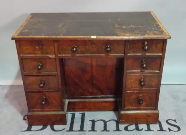 A 19th century mahogany writing desk with nine drawers about the knee on plinth base, 105cm wide x 76cm high.