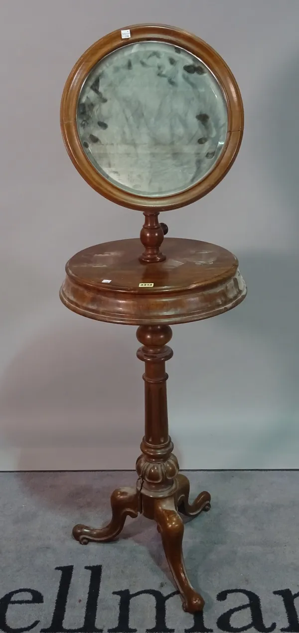 A Victorian mahogany shaving stand, with circular mirror on turned column and three downswept supports, 50cm wide x 150cm high.