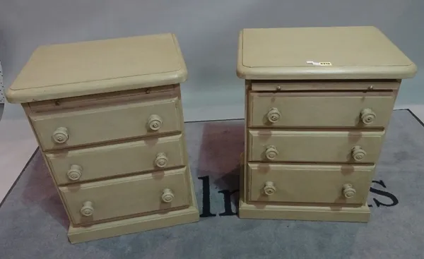 A pair of modern green painted bedside tables, each with brushing slide over three long drawers, 51cm wide x 61cm high.