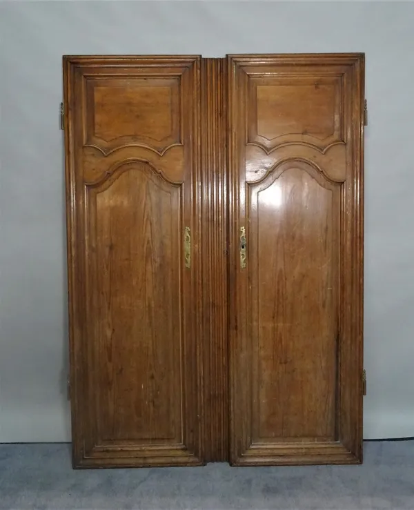 A set of early 20th century stained pine doors, with moulded panel decoration, each 56cm wide x 170cm high.