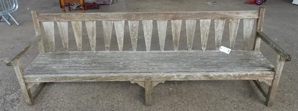 A modern hardwood garden bench, 243cm wide 87cm high.