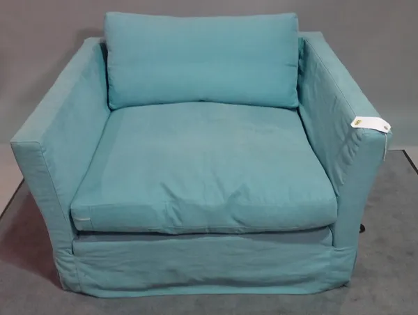 A modern low armchair, with light blue upholstery, 119cm wide x 66cm high.