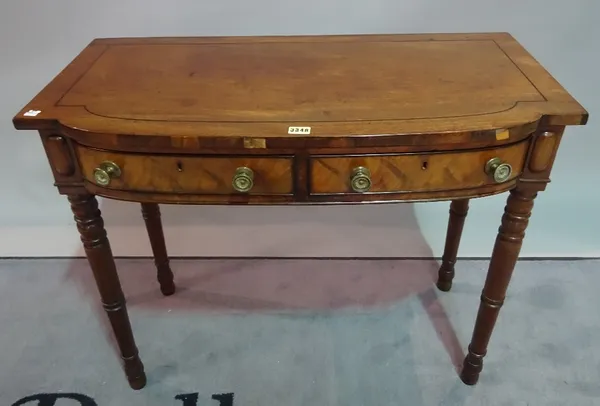 A William IV mahogany bowfront two drawer side table, on ring turned supports, 88cm wide x 72cm high.